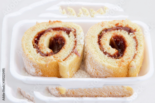 Rocambole. Rolled guava paste cake. Brazilian food. Rolled up cake with sweet filling, usually guava paste, on white background. Homemade dessert photo