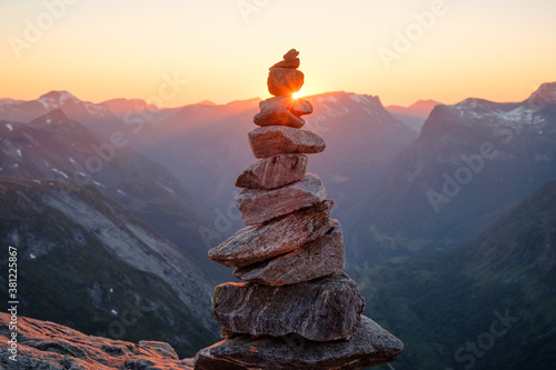 Stacked rocks with sunset overlooking mountains. Balanced rocks