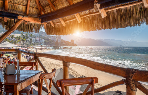 Restaurants and cafes with ocean views on Playa De Los Muertos beach and pier close to famous Puerto Vallarta Malecon, the city largest public beach photo