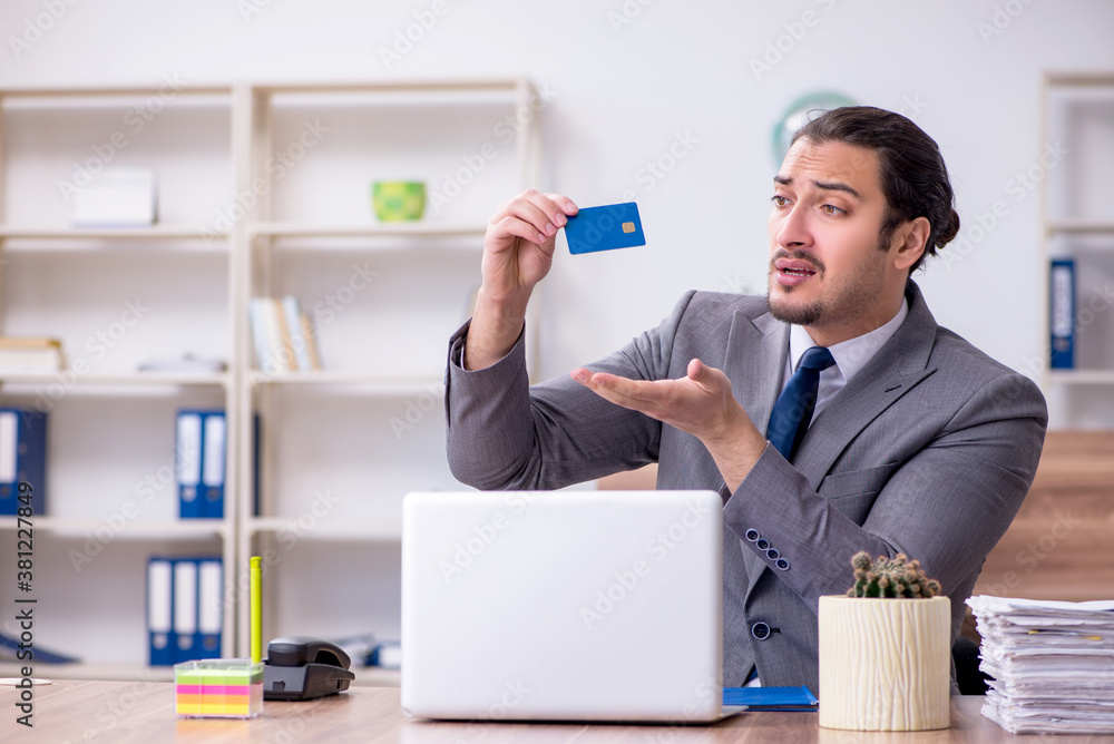 Young male employee working in the office Young male employee working in the office