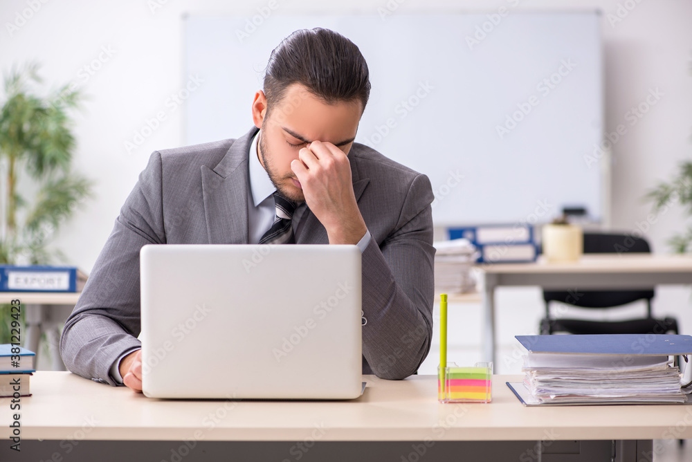 Young male employee working in the office Young male employee working in the office