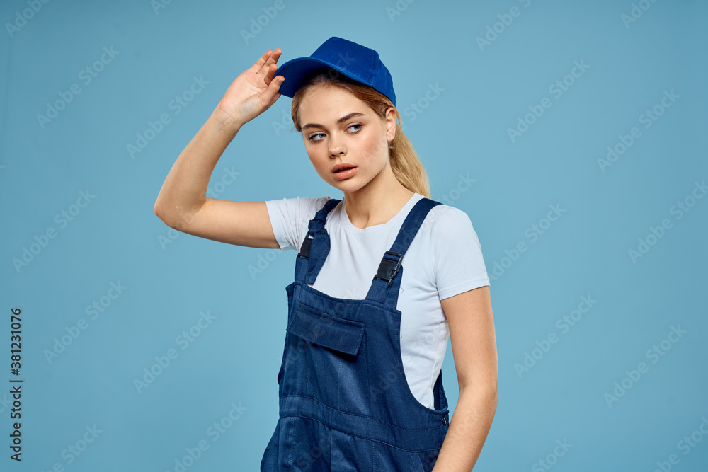Woman in work uniform blue cap carriage delivery service courier blue background Woman in work uniform blue cap carriage delivery service courier blue background