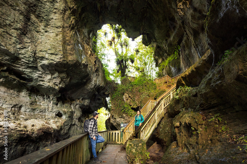 Couple hanging around Mangapohue Natural Bridge, located in Waikato, New Zealand photo