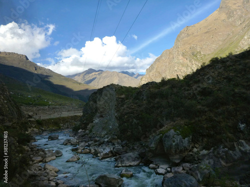 The flowing Urumbamba River of Peru, as seen from a train between Machu Picchu and Cusco photo