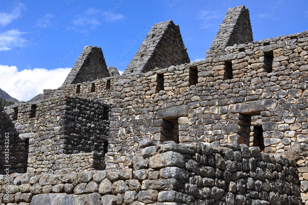 A close up view of the stone buildings and ruins inside the ancient Incan city of Machu Picchu