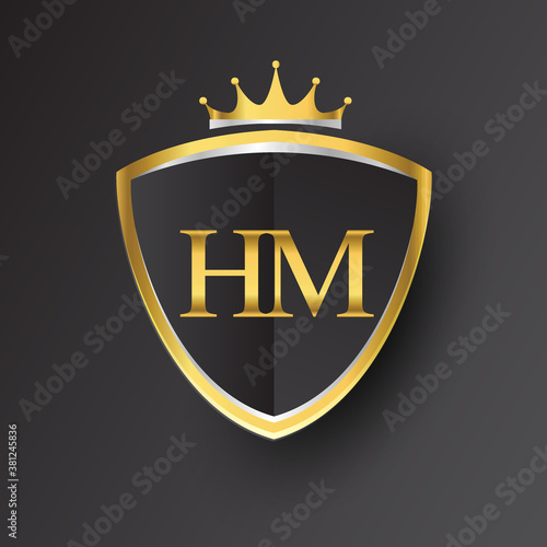 Initial logo letter HM with shield and crown Icon golden color isolated on black background, logotype design for company identity.