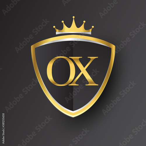 Initial logo letter OX with shield and crown Icon golden color isolated on black background, logotype design for company identity.
