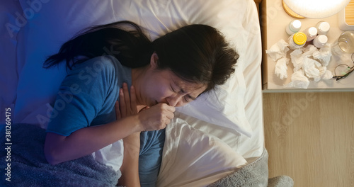 asian woman cough in bedroom photo