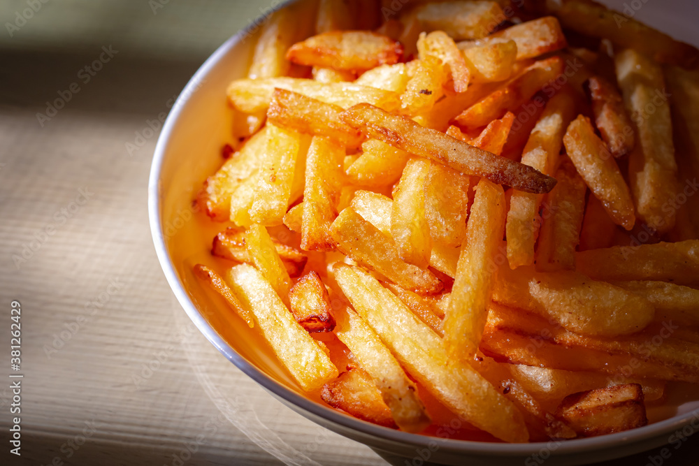 French fried in white bowl on table. Closeup food photo. French fried in white bowl on table. Closeup food photo.