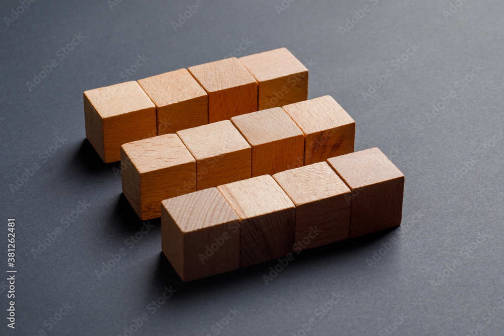 Business concept with wooden cubes on dark grey background high angle view. Business concept with wooden cubes on dark grey background high angle view.