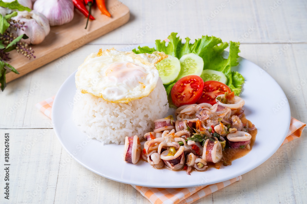 Rice topped with stir-fried Octopus dollfusi and basil with Sunny side up egg.Thai food