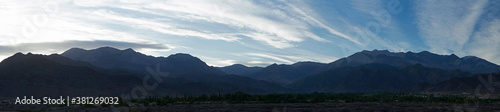 The mountains at sunrise. Beautiful panorama view of the Andes mountain range at dawn. The desert and mountains silhouette with blue colors. © Gonzalo
