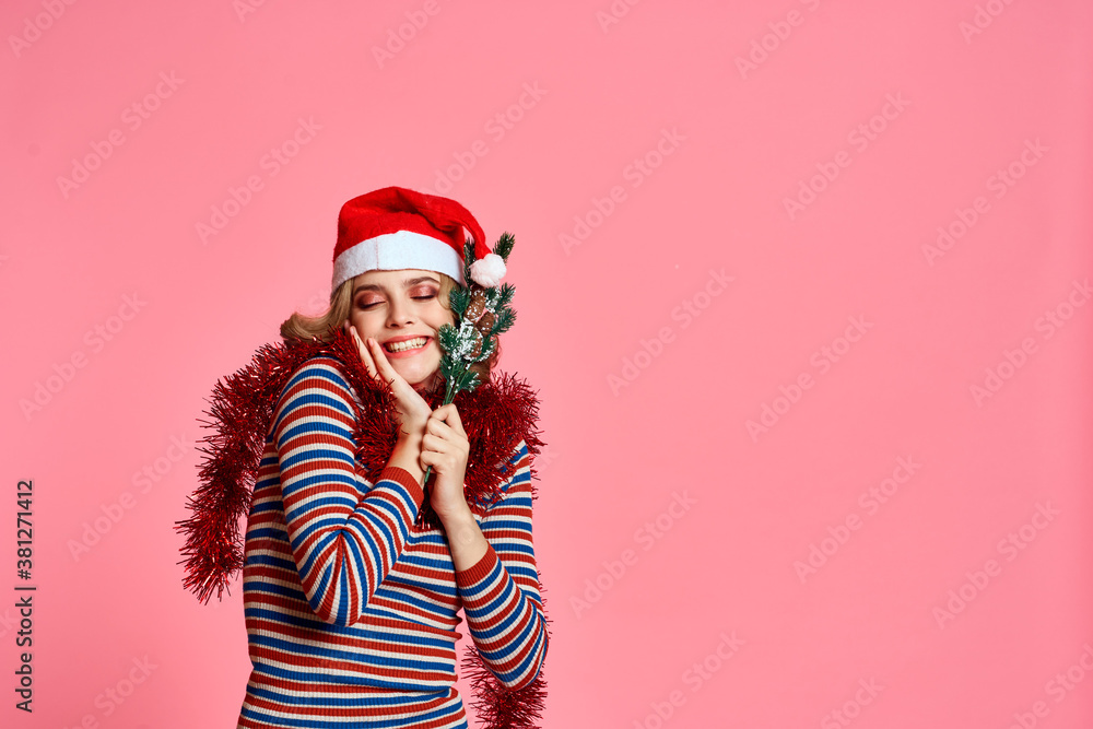 woman with christmas tree branches in hands red tinsel and festive hat pink background cropped view woman with christmas tree branches in hands red tinsel and festive hat pink background cropped view