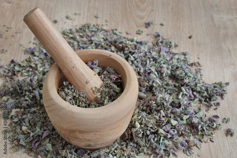 Spice mix in wooden bowl on wooden surface Spice mix in wooden bowl on wooden surface