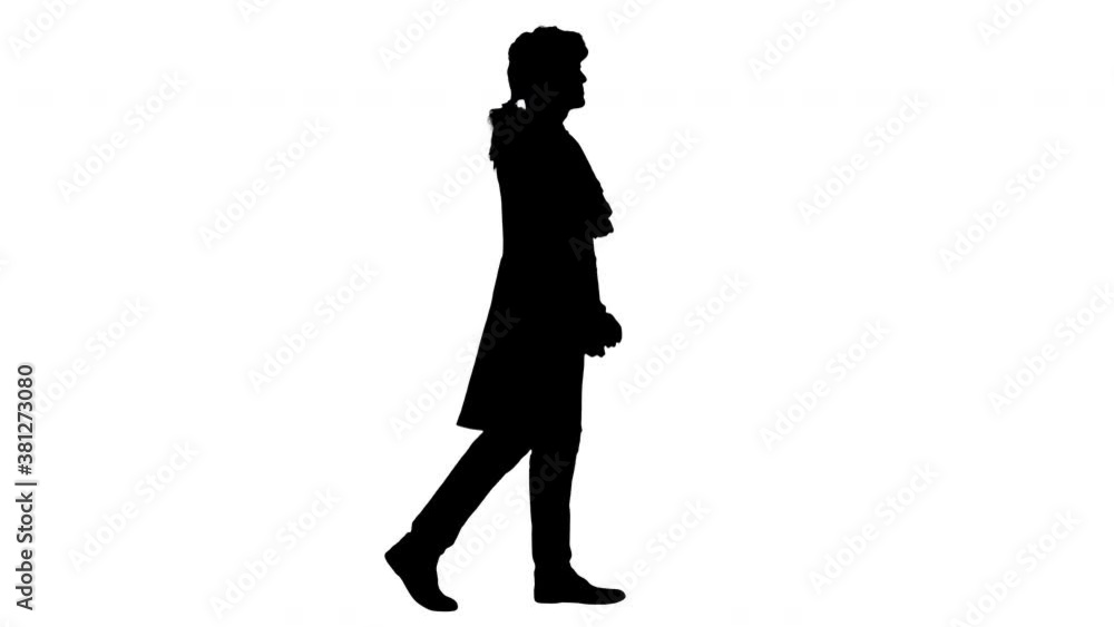 Silhouette Man in old-fashioned laced frock coat and white wig walking in a mannered way looking at camera. Silhouette Man in old-fashioned laced frock coat and white wig walking in a mannered way looking at camera.