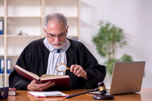 Old male judge working in courthouse