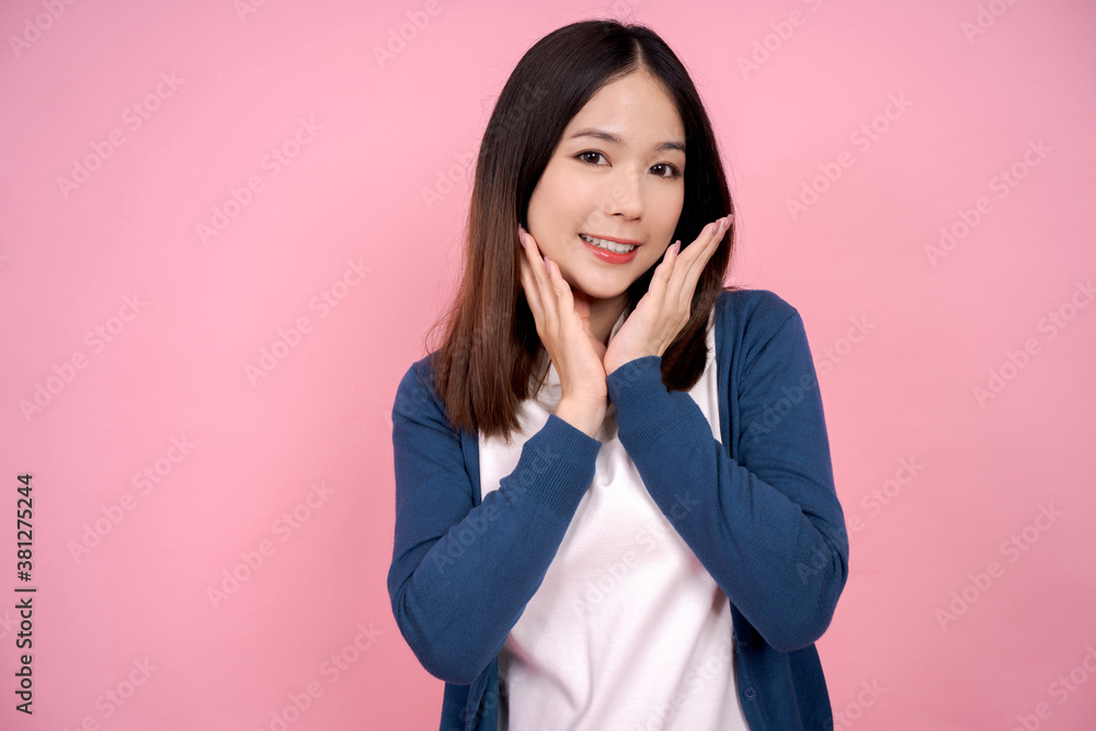 Asian woman smiling and refreshing on pink background. Asian woman smiling and refreshing on pink background.