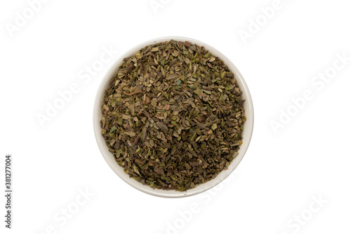 Oregano in a bowl isolated on white background.