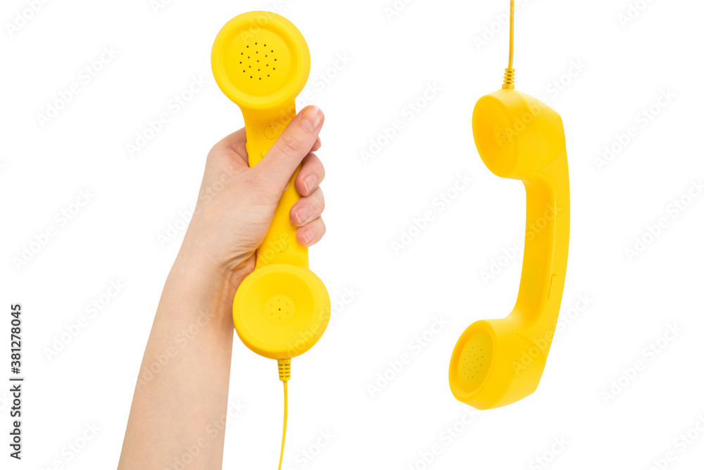 Yellow handset in woman hand isolated on white. Stock Photo Adobe Stock