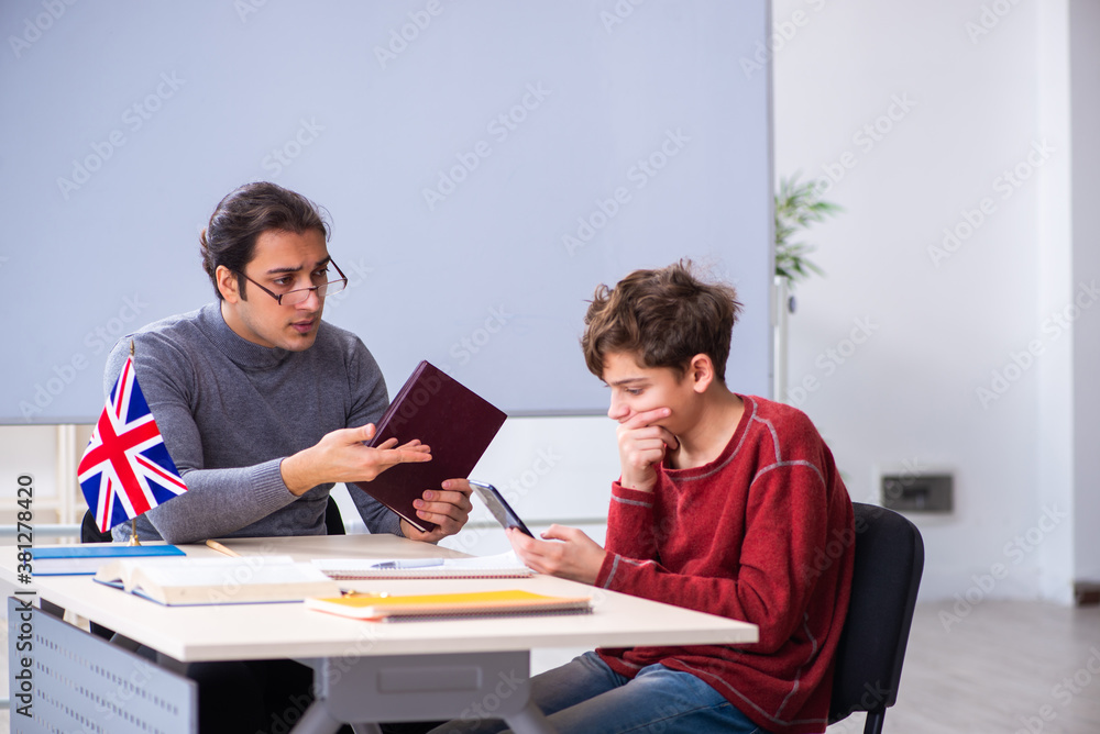 Young male teacher and schoolboy in the classroom Young male teacher and schoolboy in the classroom