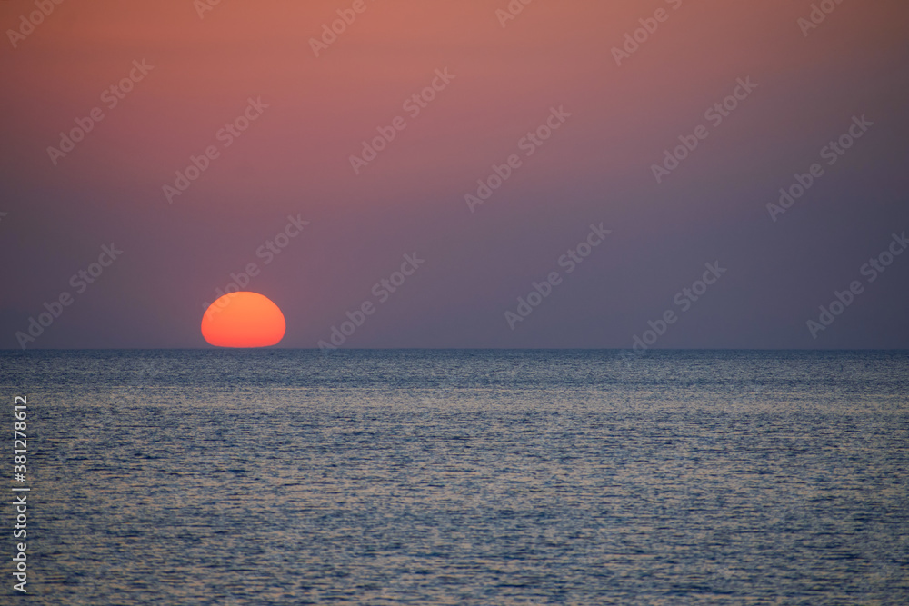 The sun is lost in the sea on a beautiful sunset