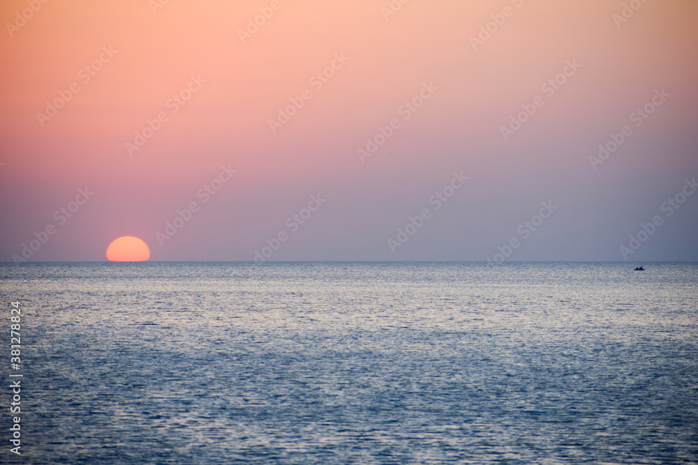 The sun is lost in the sea on a beautiful sunset