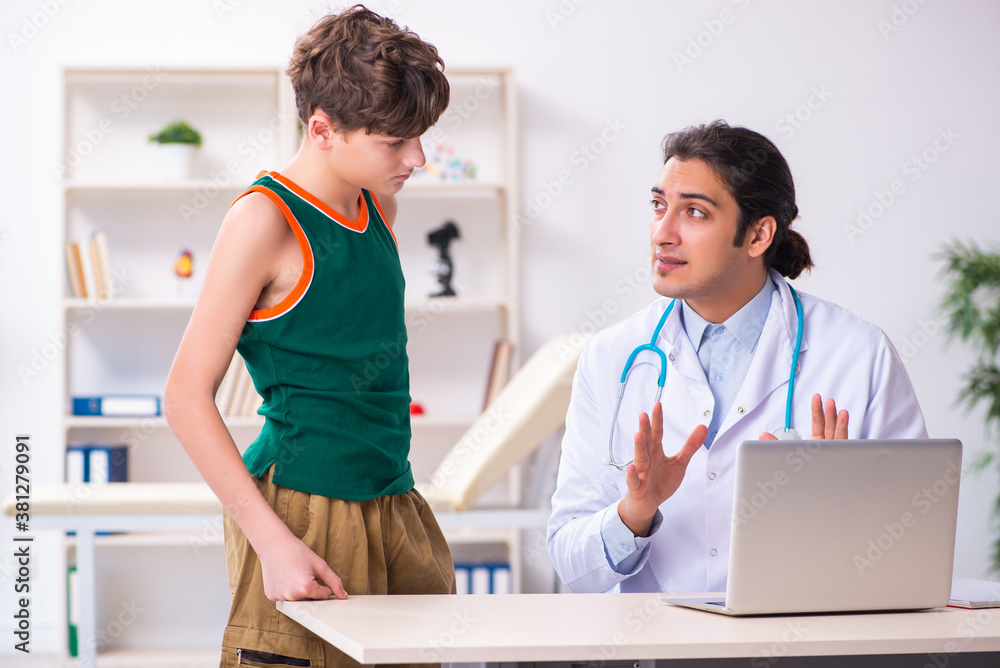 Sick boy visiting young male doctor pediatrician Sick boy visiting young male doctor pediatrician