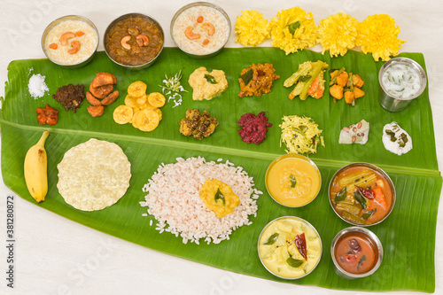 Traditional Onam sadhya, boiled rice, served for Kerala Indian festival  with curries Sambar, Rasam, Pulisseri, Avial, Thoran, Papadum, Payasam, Banana, Yogurt or Buttermilk, chips photo