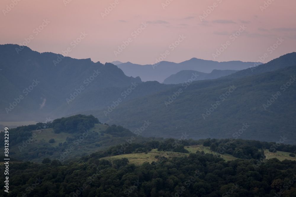 Early morning one hour before dawn. Silhouettes of mountains in the morning haze. Lagonaki Plateau, Republic of Adygea, Russia