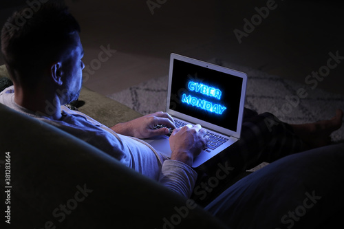 Man with laptop late in eve...
