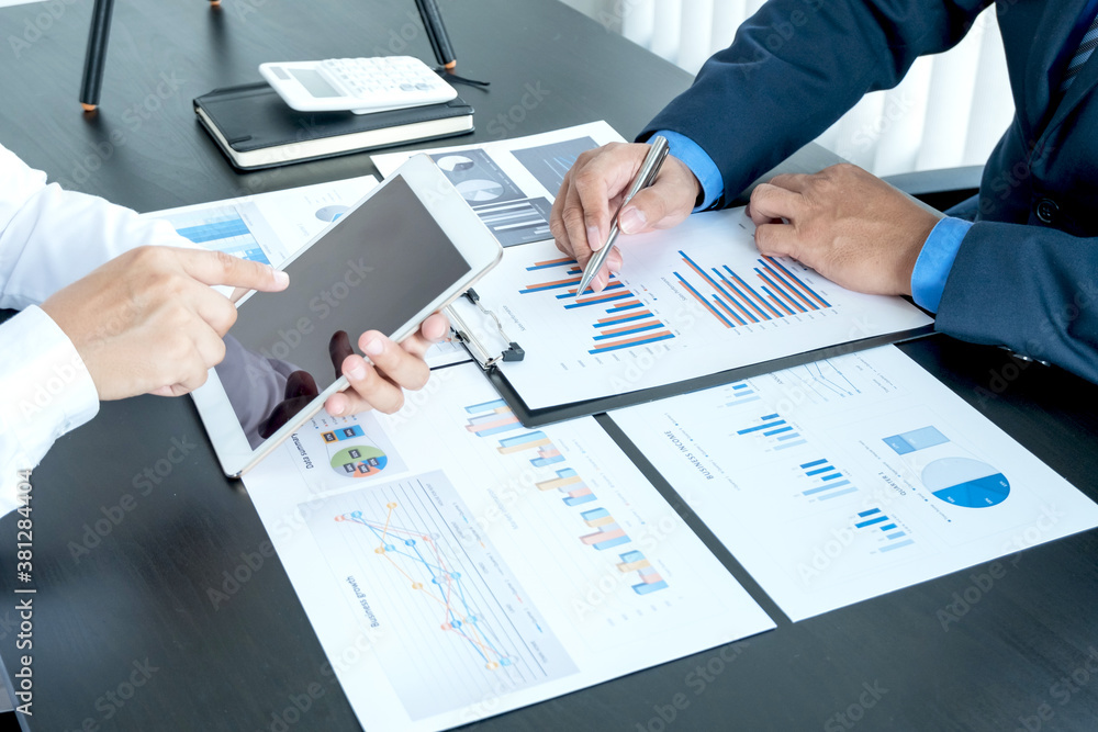 Two business leaders talk about charts, financial graphs showing results are analyzing and calculating planning strategies, business success building processes Two business leaders talk about charts, financial graphs showing results are analyzing and calculating planning strategies, business success building processes