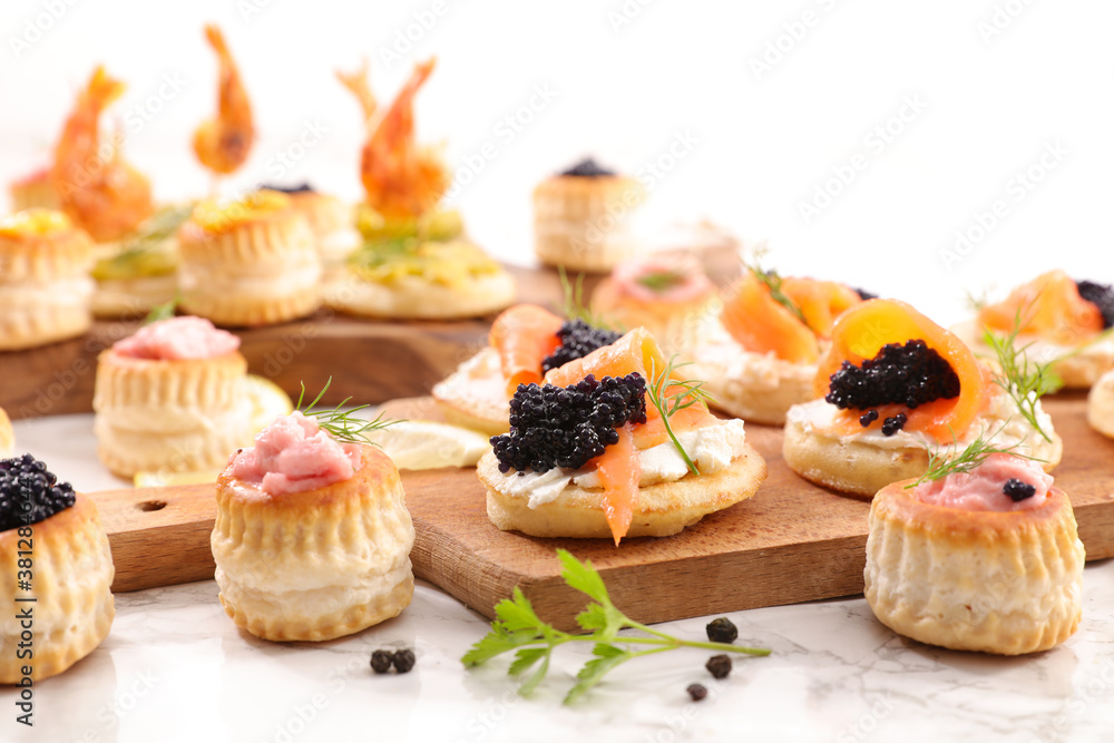 festive canape, buffet food- puff pastry with caviar, salmon and seafood cream festive canape, buffet food- puff pastry with caviar, salmon and seafood cream