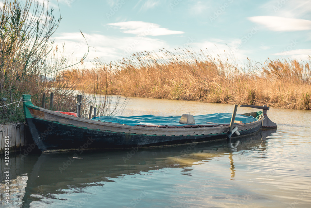 a small boat parked on the river