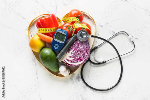 Vegetables, stethoscope, measuring tape, lancet pen and glucometer on white background. Diabetes concept