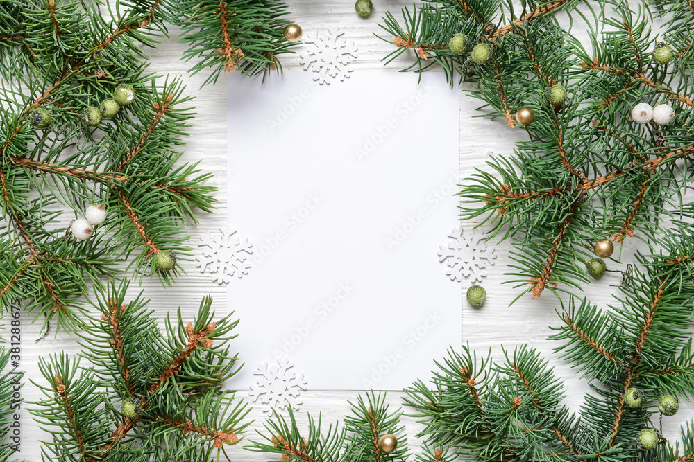 Beautiful Christmas decorations with empty card on white wooden background Beautiful Christmas decorations with empty card on white wooden background