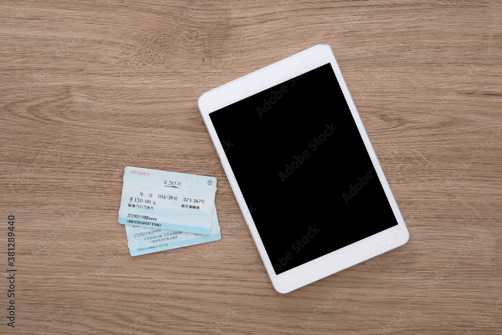 Tablet computer and two train tickets home