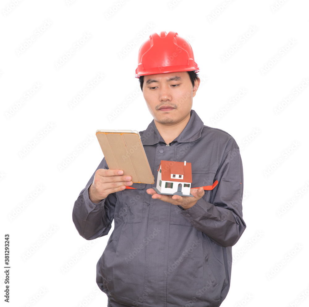 Construction engineer holding a tablet and a small house model in hand