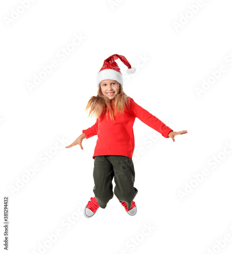 Jumping little girl in Santa Claus hat on white background