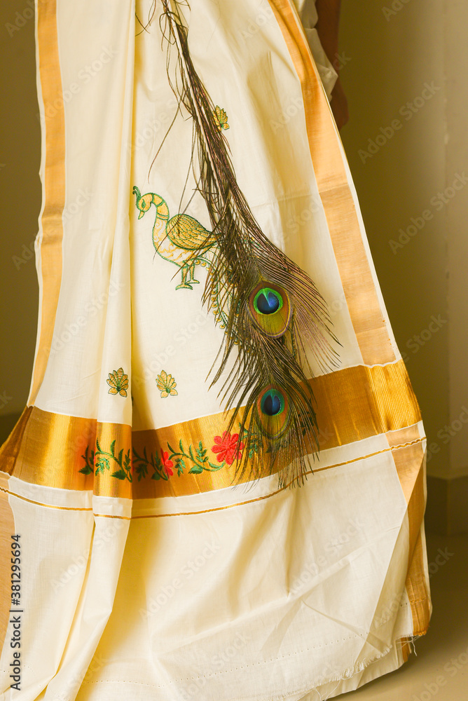 Traditional white silk sari / saree with golden details, woman use to