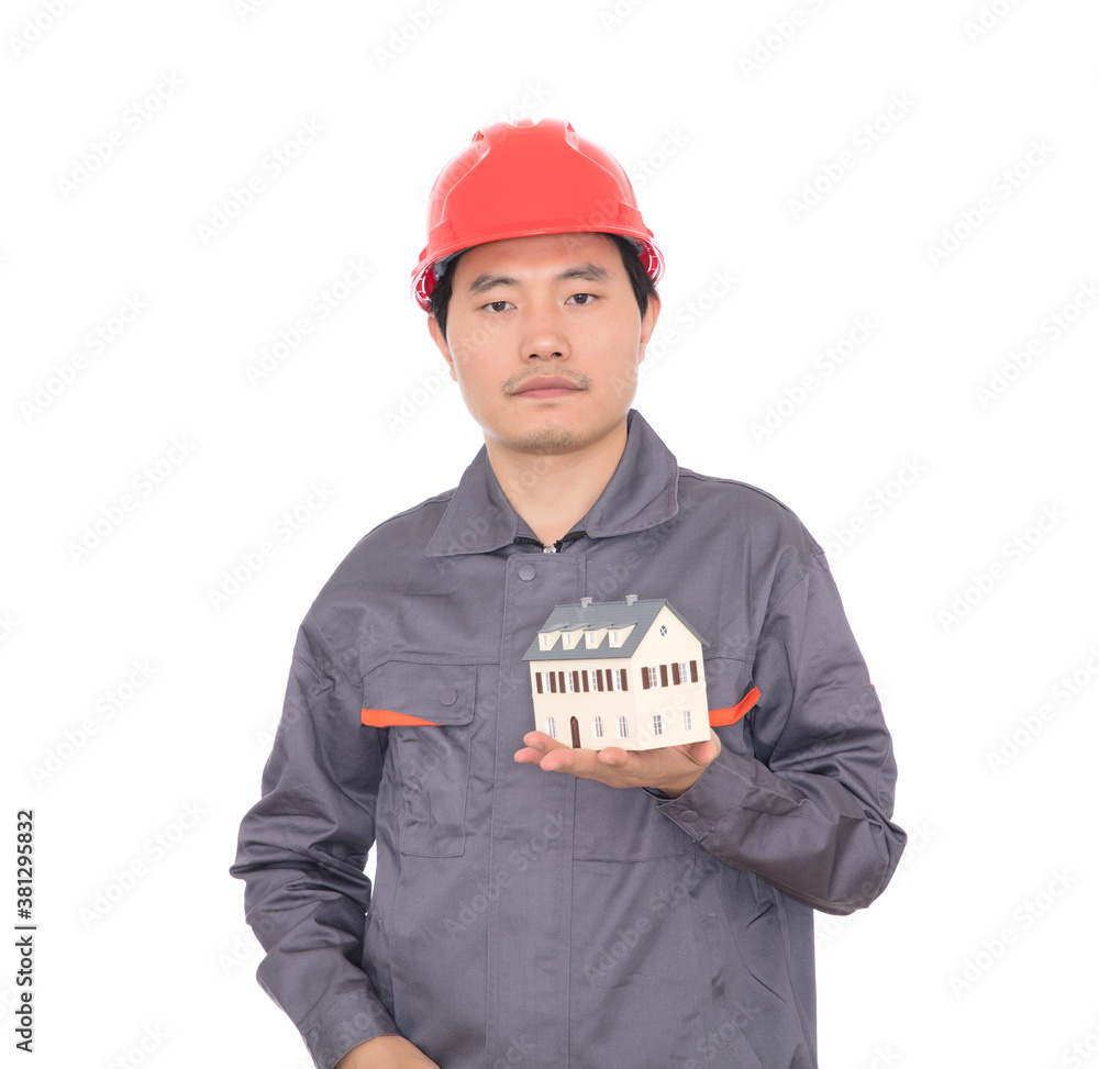 Architect wearing red hard hat viewing small house model in hand Architect wearing red hard hat viewing small house model in hand