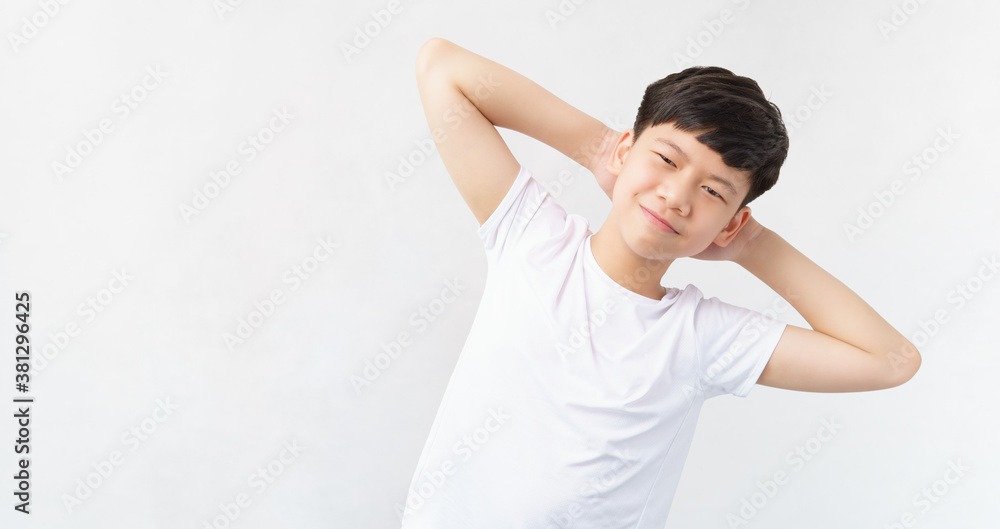 Studio portrait of a good looking, friendly, sporty, fit and healthy asian teenage boy with confident smile. He standing hands behind head and bending his body to his side. Stretching, Good morning. Studio portrait of a good looking, friendly, sporty, fit and healthy asian teenage boy with confident smile. He standing hands behind head and bending his body to his side. Stretching, Good morning.