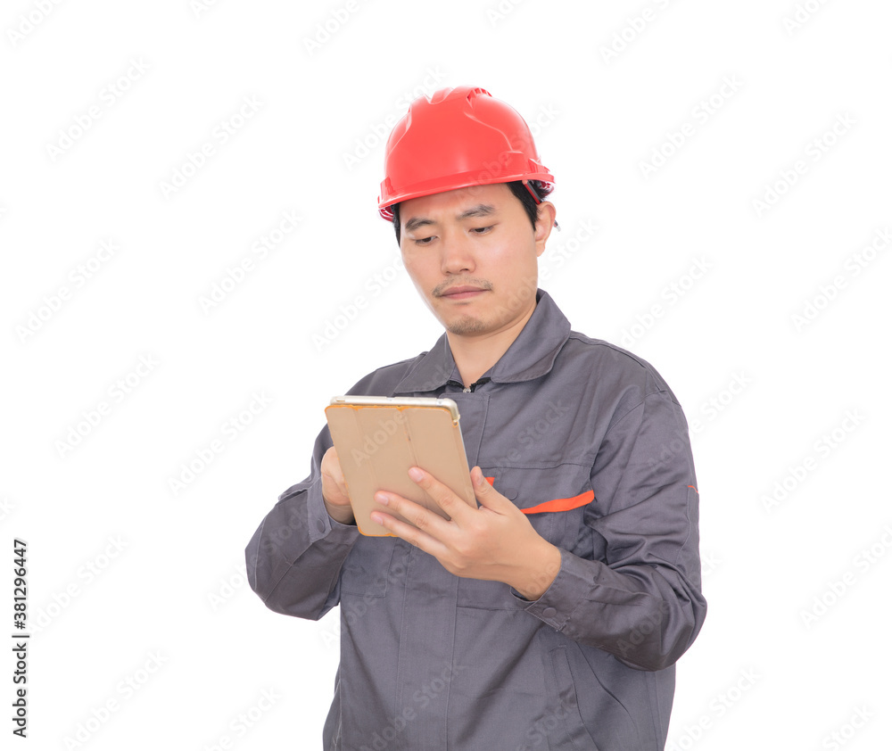 Worker wearing red hard hat holding tablet in hand Worker wearing red hard hat holding tablet in hand