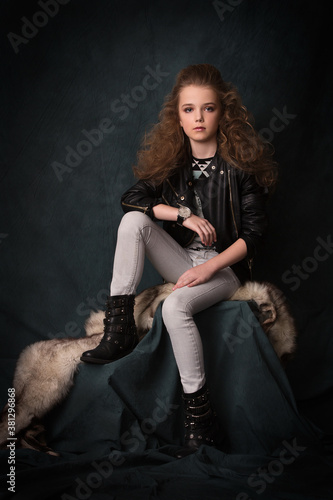 Young little girl posing like a fashion model