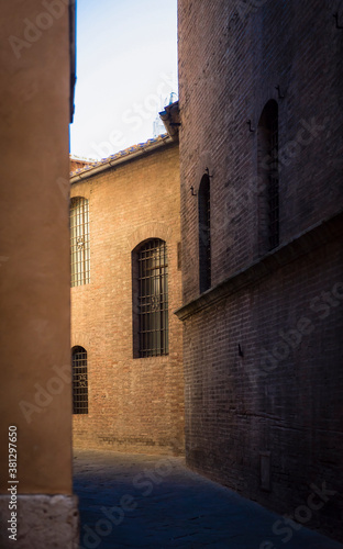 Narrow street of Siena in Tuscany, Italy, in the morning light © Sergey