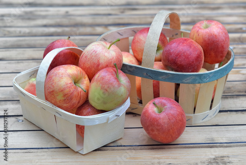 group of red apples in little baskets on a wooden table