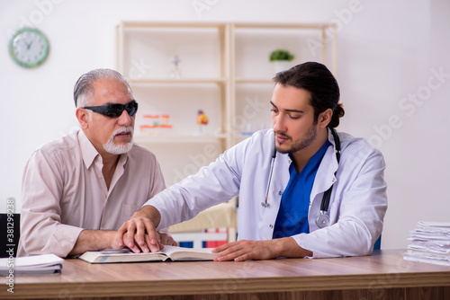 Old blind man visiting young male doctor