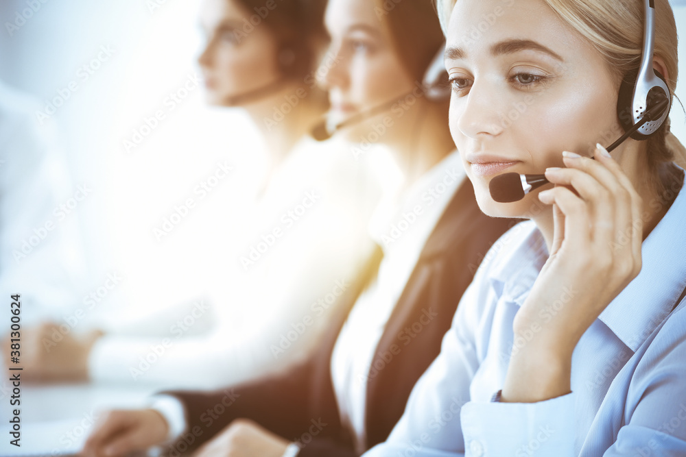 Call center and business people concept. Beautiful business woman with headphones consulting clients Call center and business people concept. Beautiful business woman with headphones consulting clients