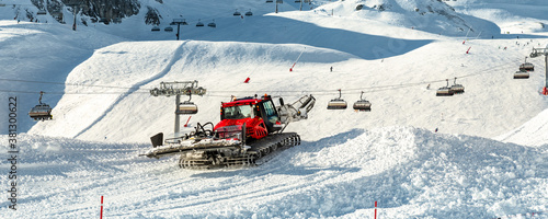 Cuadro en lienzo Red modern snowcat ratrack with snowplow snow grooming machine preparing ski slope piste hillalpine skiing winter resort Ischgl in Austria