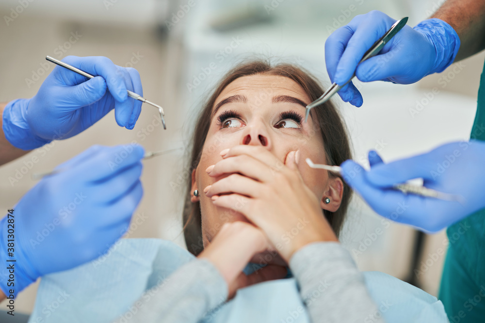 Fototapeta premium Male dentist and woman in dentist office