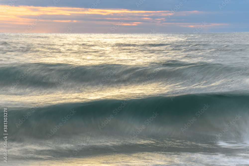 Beach in the evening with moving water which brings an effect to the surface of the sea. Beach in the evening with moving water which brings an effect to the surface of the sea.